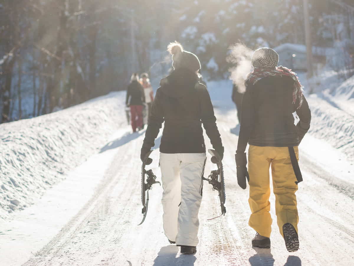 Skiers walking on a snowy path